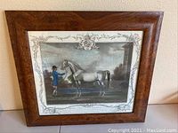 Framed engraving in brown wood frame measuring 18 x 17 inches, showing full artwork and frame.