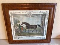 Front view of the framed aquatint engraving showing the horse and handlers scene with ornate border and crest.
