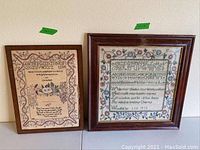 Photo showing both samplers side by side. Left sampler is smaller (13x17), wood frame, no glass. Right sampler is larger (19x19), wood frame with glass. Both have alphabet embroidery, floral designs and verses.