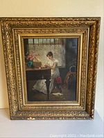 Full view of framed painting showing woman playing piano in white dress, ornate gilt frame with wear.