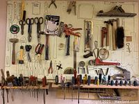 Wide view of pegboard with all tools hung and organized.