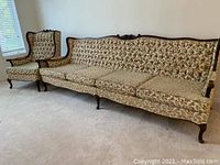 Photo showing the wing back chair and the 4-cushion couch, capturing upholstery pattern and carved wood frame craftsmanship.