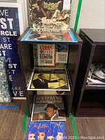 Vinyl records displayed on storage rack, including Ella and Basie, Duke Ellington, and Frank Sinatra albums
