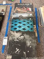Photo showing 8 The Who vinyl albums stacked with cover art visible including 'The Kids Are Alright' and 'Tommy' albums