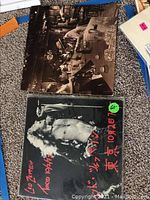 Two Led Zeppelin vinyl albums from Tokyo 1972 with front covers showing concert images and Japanese text, one with a protective cover.