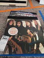 Front cover of Metallica limited edition picture disc album The $5.98 E.P. Garage Days Re-Revisited featuring band members and sticker about remastering and limited edition status.