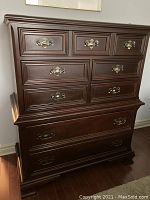 Front view showing entire 7-drawer configuration and brass hardware