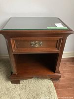 Front view of one night table showing drawer closed, glass top and base