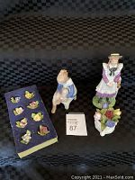 All items in lot: Anne of Green Gables figurine, B&G Copenhagen Girl on Chair figurine, Aynsley May Tulip floral figurine, and Royal Adderley miniature floral pieces on black checkered fabric.