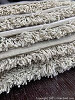 Close-up photo showing the short shag pile texture and backing of the area rug, highlighting density and softness of fibers.