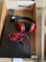 Top view showing Blu-ray player with remote, power cord and Sony headphones in box.