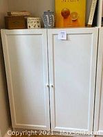 Closed IKEA Billy bookcase with Oxberg doors, showing white panel doors with round white knobs.