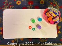 Top view of the white kids table with some Play-Doh accessories on it (not included). The table surface is clean with a seam down the center.