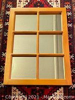 Photo showing the front of the mirror with six rectangular panes and solid wood mullioned frame.