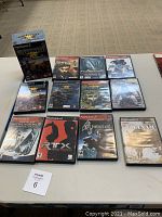 Top-down angled view of all PS2 games and Socom headset illustrating quantity and box conditions.