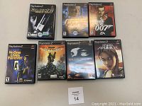 Seven PlayStation 2 game cases arranged in two rows showing clearly the front cover and titles.