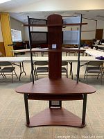 Front view of wood and metal corner computer desk with shelves and vertical support