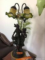 Full lamp including base with two dancing women and yellow-green petal-style glass lamp shades