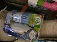 Close-up of Air Wick Freshmatic Aqua Mist automatic air freshener in original packaging with motion sensor.