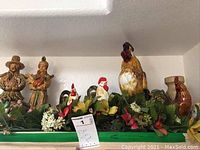 Full overview of the collection on shelf including roosters, pilgrim figures, artificial flowers