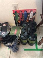 Full lot overview showing propane canisters, boxed lighters, quick pump, and water bottle