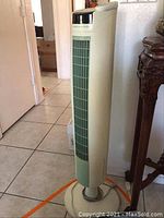 Full side view of the Sharper Image tower fan showing its height and design.