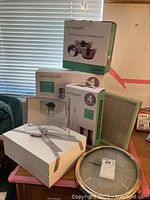 Boxes and packaging showing Servapptit canisters, glass set, picture frame packaging, and wine glass set box