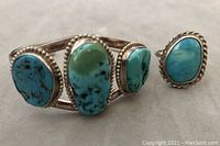 View of both turquoise stone cuff bracelet and ring showing mottled coloration and sterling silver borders.