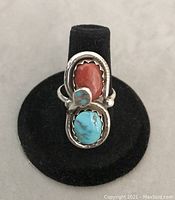 Front view of the Zuni snake ring showing turquoise and coral stones with snake design wrapping around.