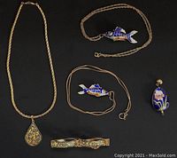 Overview of all 4 jewelry pieces including fish pendants, pear-shaped pendant, and bracelet.