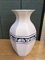 Front angle view of the large Dedham Pottery vase showing crackled glaze and blue rabbit border pattern with flared rim.