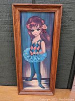 Full view of framed ballerina girl print in wood frame