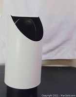 Front and side view of mid century lamp showing cylindrical white body and black top opening