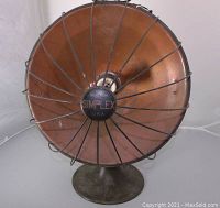 Front view of the Boston Simplex heater showing copper cone, wire guard, and central hub labeled SIMPLEX U.S.A.