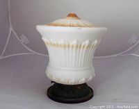 Side view of the glass ceiling light fixture showing white opaque glass with burnt cyan gradient and ridged filigree style taper, mounted on a dark metal base with visible wear.