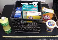 Overview photo showing crate filled with laundry products and some external items including Crystal White oil soap, Arm & Hammer boxes, Borax, and Oxi Clean powder.