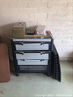 Front and side view of Husky tool cabinet and items placed on and beside it