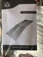 Front cover of the Home Com assembly ramp instruction manual showing the folding aluminum ramp design with parallel slats
