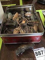 Container of assorted silver flatware and bison figurine