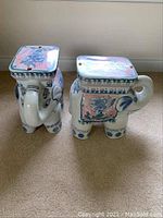Two ceramic elephant plant stands showing overall shape and top surfaces.