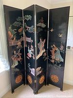 Full view of four-panel screen showing hand-painted Asian scenes on black lacquered panels