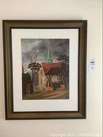 Framed painting with full view showing old Saxon church with green steeple and red roof, surrounded by trees