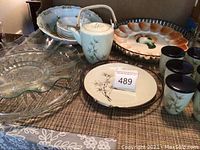 Overview of serveware items including porcelain tea set with bamboo motif, glass and ceramic serving bowls, and rooster egg plate.