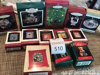 Photo of multiple Hallmark Keepsake ornament boxes arranged together showing assortment in themes and box sizes.