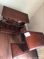 Overview of two wood tables including the magazine rack and trapezoid sofa table, showing tops and side views