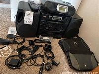 Full view of JVC stereo system with two speakers, Philips Magnavox portable CD player on top, accessories laid out in front.