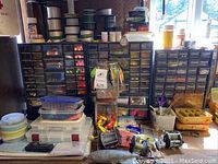 Full workbench view showing reels, tackle boxes, drawer organizers, line spools