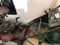 Full view of the Toro Super Recycler lawn mower showing red deck, black engine, and attached grass catcher basket.