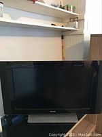 Philips flatscreen TV front view showing the screen and base stand.