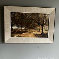 Full view of framed oil painting hanging on wall